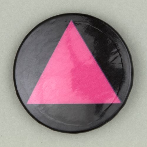 button badge of a pink triangle on a black background